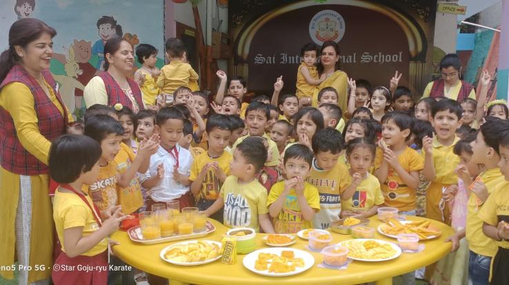 Little kids of Sai International School wear yellow clothes to celebrate Mango Day