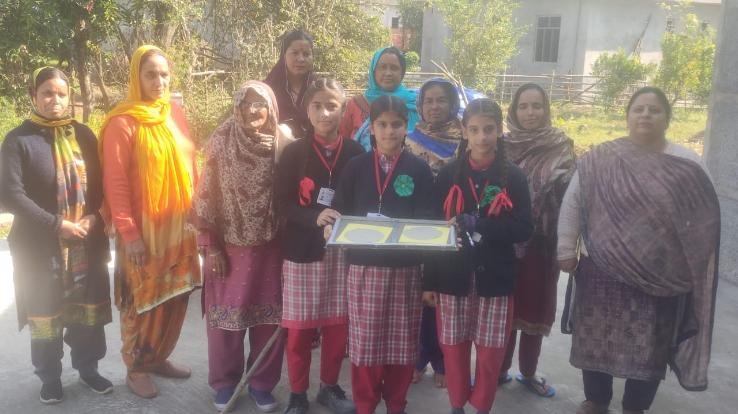 Girls students are teaching the method of making paper from the leaves of Tulsi plant.