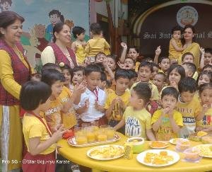 Little kids of Sai International School wear yellow clothes to celebrate Mango Day
