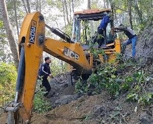 The mountain fell on the JCB cutting the road