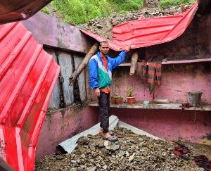 Broken roof of the kitchen of Danthal school of Sangrah block due to road debris