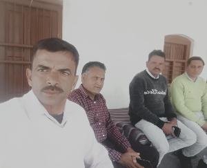 Teachers of Jujpur school telling people the merits of government schools